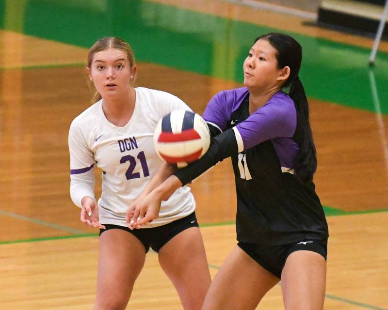Downers Grove North's Nicole Liu, right, bumps the ball during the game on Tuesday Oct. 22, 2024, while traveling to take on York High School in Elmhurst.