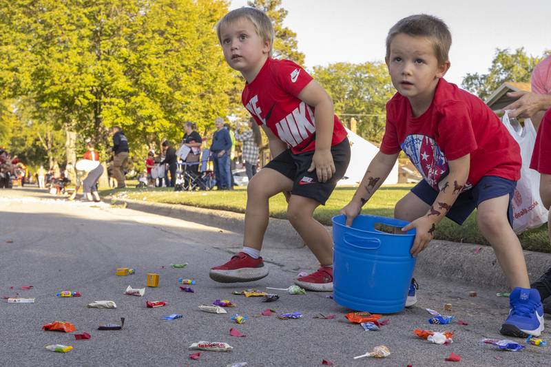 Several kids gather candy being thrown out during the Hall High School Homecoming parade in Spring Valley on September 26, 2024.