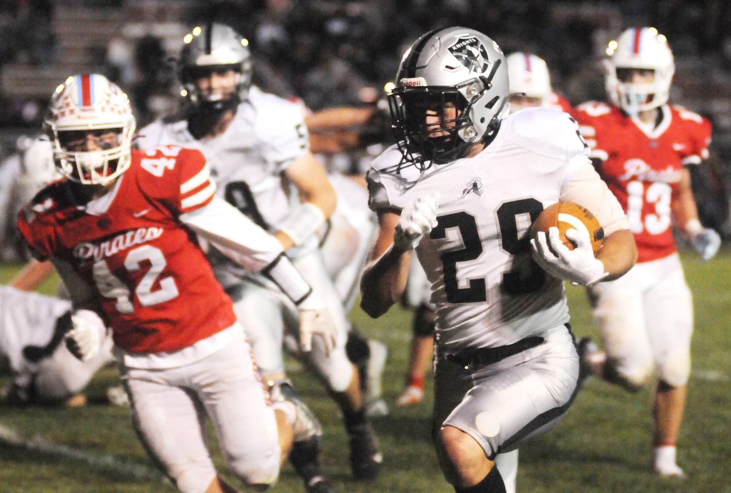 Kaneland's Chris Ruchaj carries the ball downfield past the defense of Ottawa's Branden Aguirre at King Field on Friday, Sept. 23, 2022.