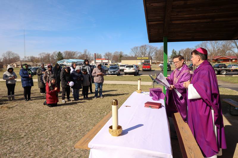 Bishop Chris Glancy, of St. Patrick’s Catholic Church, right, and Rev. Matt Pratscher, of St. John Paul II Catholic Church, lead a Mass and prayer service held in Aroma Park on Thursday, March 12, 2026, following the EF-3 tornado that tore through the town and Kankakee County on March 10.