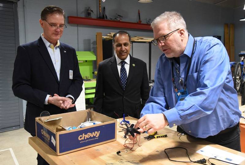 Boys & Girls Clubs of Dundee Township CEO Drew Glassford, left, and U.S. Rep. Raja Krishnamoorthi, center, watch a presentation by Jack VanNoord. The congressman visited the organization's impact center in Carpentersville on Friday, Jan. 20, 2023, to present $2 million to support the opening of another center.