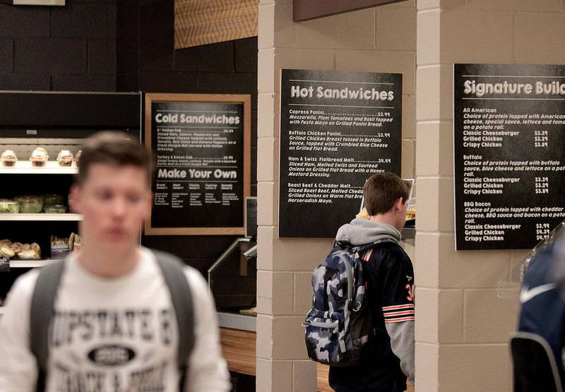 Students at St. Charles North High School peruse their lunch options in the school's cafeteria. Batavia and St. Charles dropped the federal lunch program at the high school level this year.