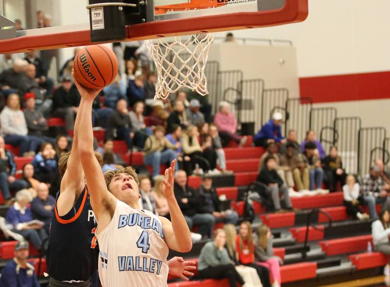 Bureau Valley's Landon Hulsing (4) runs in front of Pontiac's Kerr Bauman (24) to score a basket during the Colmone Classic tournament on Monday, Dec. 5, 2022 at Hall High School in Spring Valley.