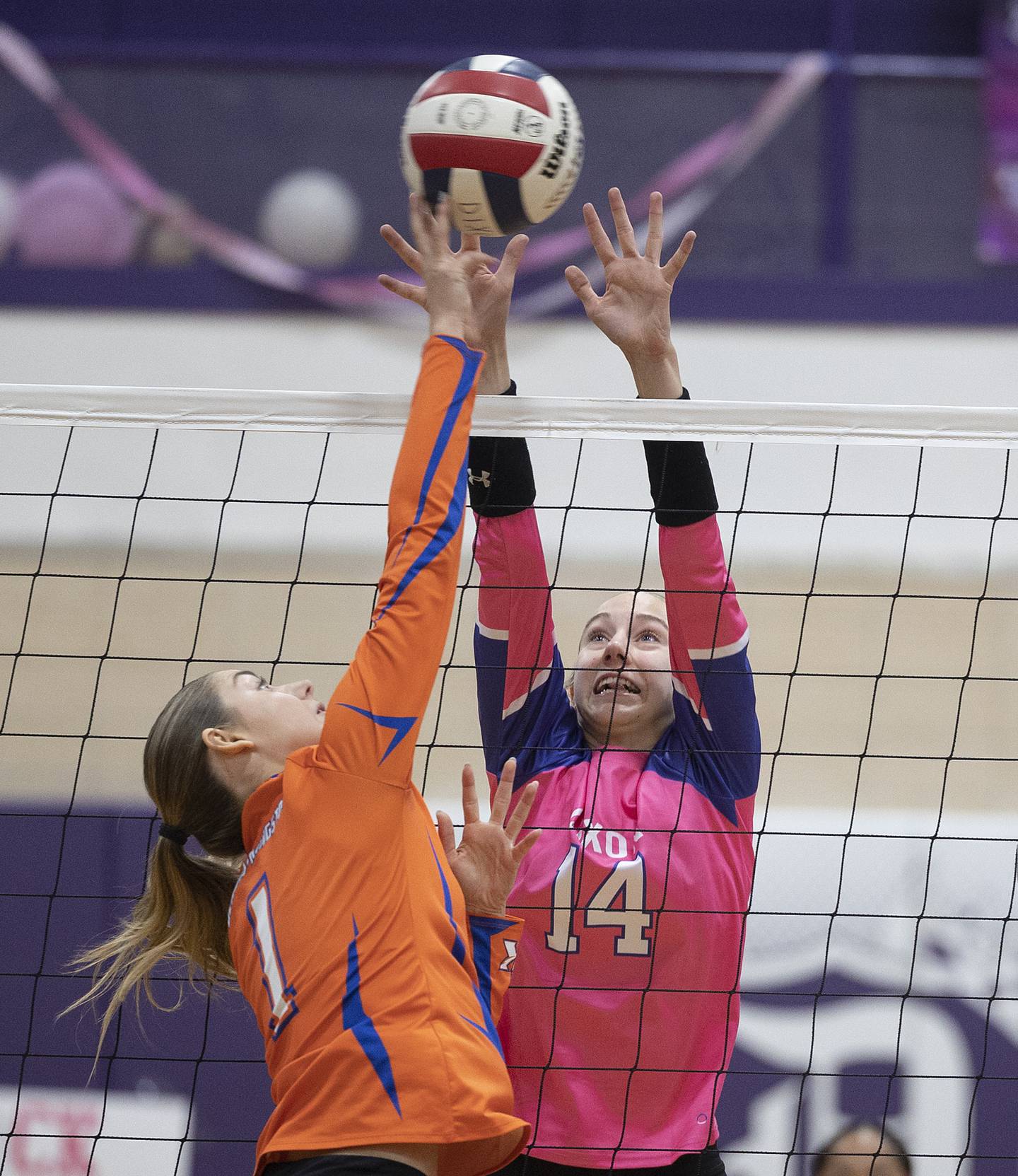 Dixon’s Leah Carlson goes up for a block against Genoa-Kingston’s Presley Meyer Thursday, Oct. 17, 2024.