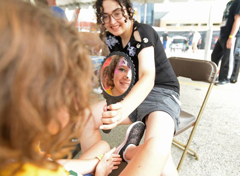 Katrina Neururer of Glen Ellyn reacted to her face painting done by Jessica Ronin of Indian Head Park during the Downers Grove Octoberfest Saturday, Sept. 16, 2023.