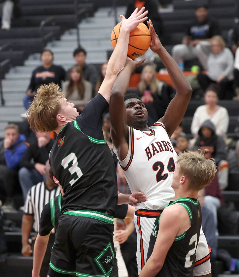 DeKalb's Myles Newman has his shot blocked by Rock Falls' Cole Heald during their game Tuesday, Dec. 2, 2025, at DeKalb High School.