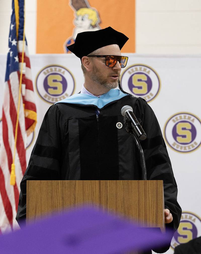 Serena High School Principal Adam Kueltzo, sports sunglasses as he finishes delivering the opening remarks during graduation on Saturday, May 24, 2025 at Serena High School..