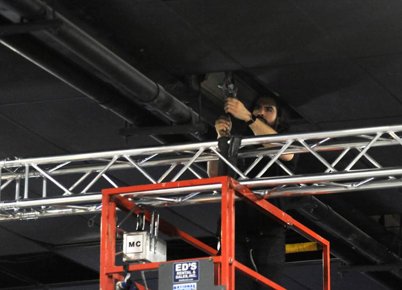 A worker installs the rigging for stage lights on Wednesday, April 14, 2022, at The Vixen, 1208 N. Green St. in McHenry. Formerly the McHenry Downtown Theater, it is reopening for live shows as part of the theater's pivot away from being a movie theater. As part of the renovations, the location's multiple movie theaters were combined into one large theater.