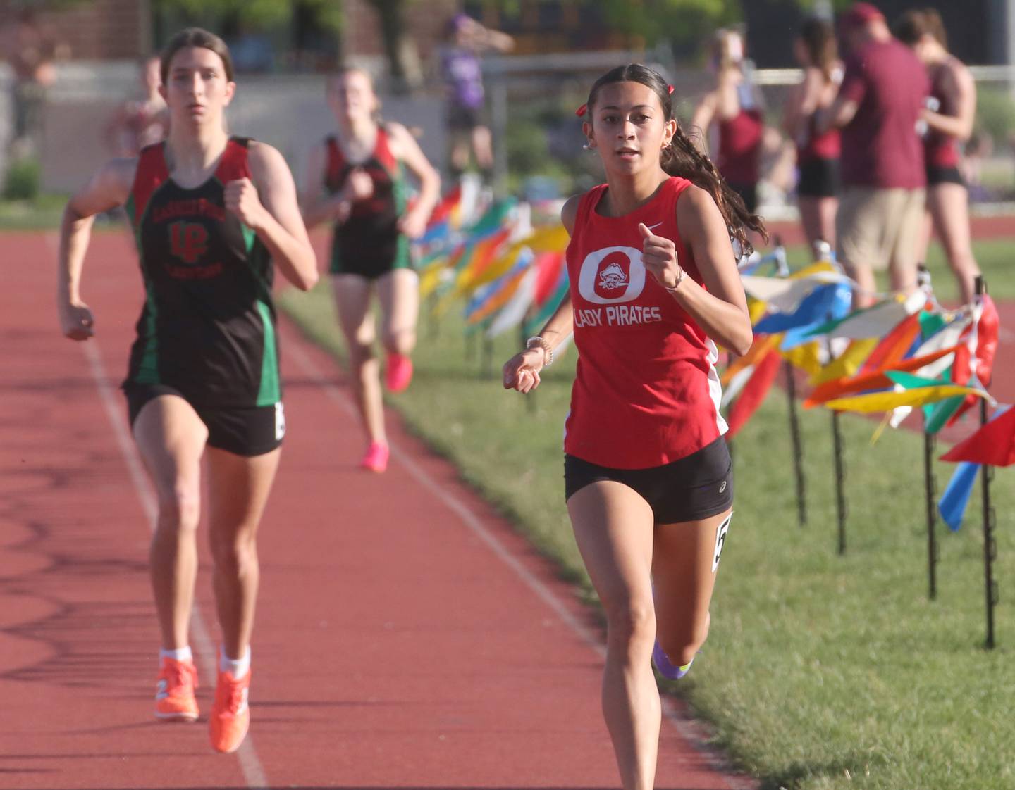 Ottawa's Shaylen Quinn and L-P's Ashlee Lord run in the 800-meter race during the Interstate 8 Conference Meet on Friday, May 3, 2024, at the L-P Athletic Complex in La Salle.