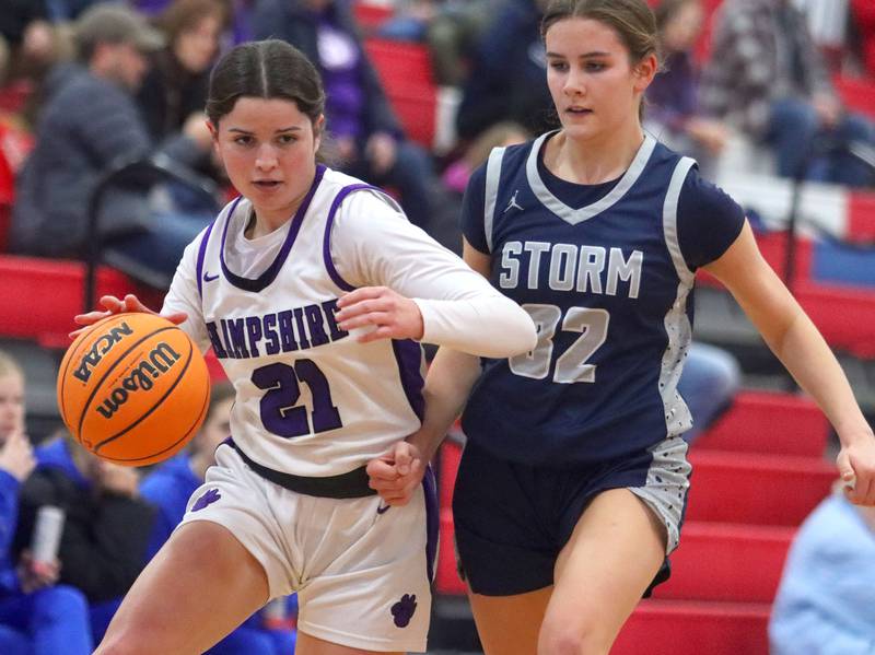 Hampshire’s Veronica Dumoulin, left, drives past South Elgin’s Kylie Germano Finn in varsity girls basketball Komaromy Classic tournament  action on Monday, Dec. 29, 2025, at Dundee-Crown High School in Carpentersville.