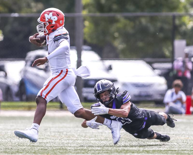 Downers Grove North's Caden Chiarelli (4) makes a divin tackle attempt during football game between Downers Grove North at Morgan Park Saturday, Aug 30, 2025  in Chicago.