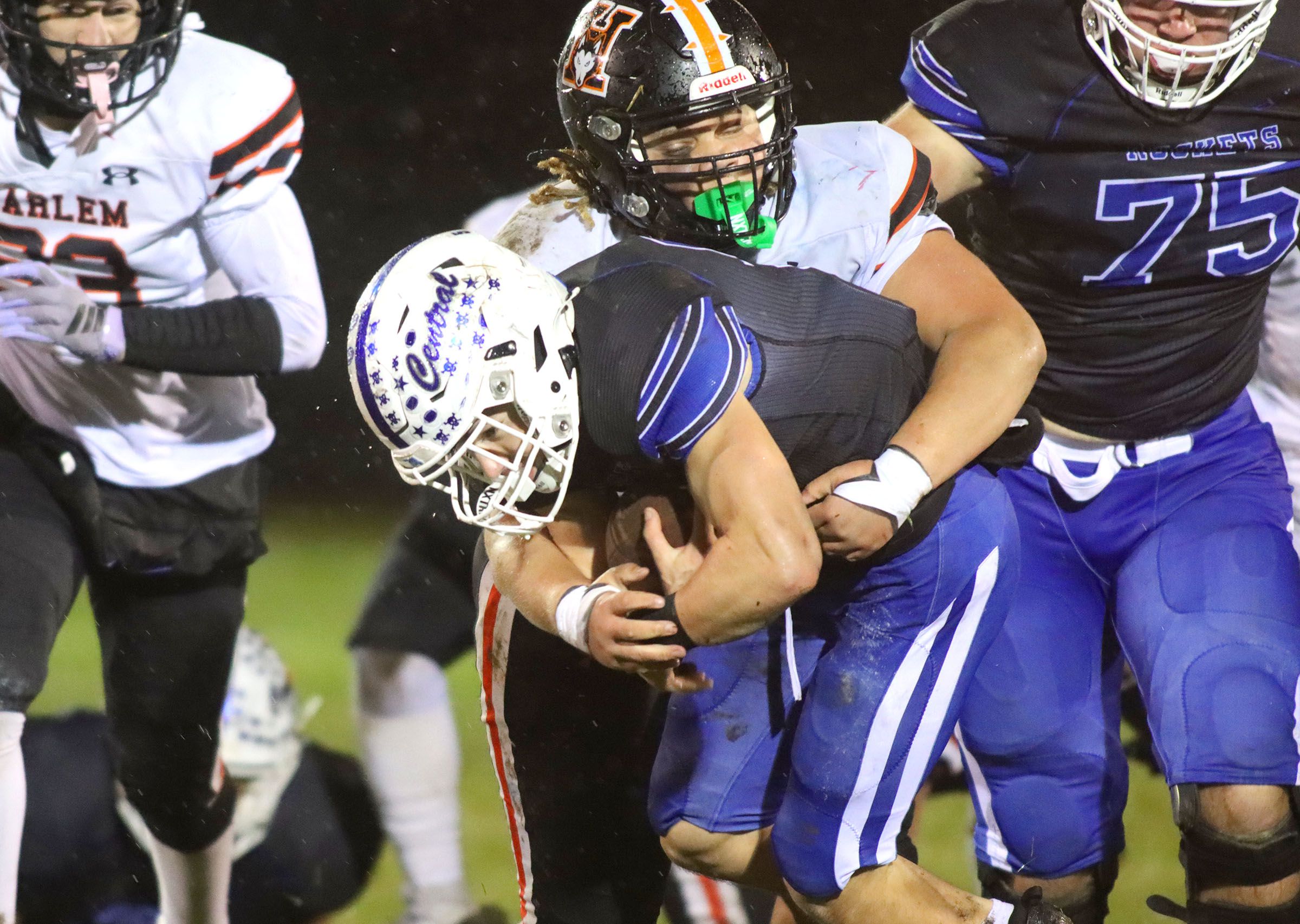 Burlington Central’s Parker Auxier moves the ball against Harlem in IHSA football Class 6A second-round playoff action at Central High School in Burlington on Saturday, November 8, 2025.