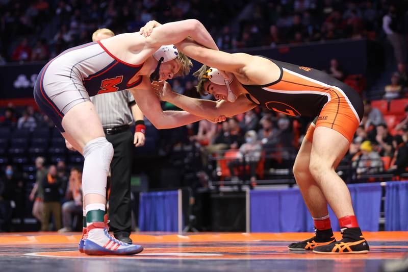 Marmion’s Jack Lesher (left) tangles up with Libertville’s Josh Knudten in the Class 3A 182lb. semifinals at State Farm Center in Champaign. Friday, Feb. 18, 2022, in Champaign.