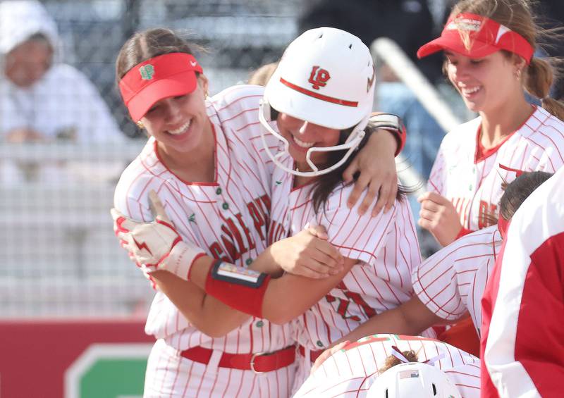 L-P's Anna Riva hugs teammate Brianna Ruppert after hiitting a home run against Ottawa on Wednesday, April 29, 2026 at the L-P Athletic Complex in La Salle.