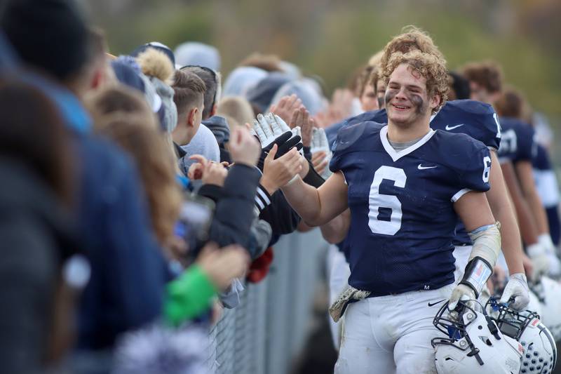 Cary-Grove’s Charlie Ciske leads the Trojans in their post-game receiving line of fans after a win over Belvidere North in IHSA Class 6A quarterfinal playoff football action on Saturday, Nov. 16, 2024, at Al Bohrer Field on the campus of Cary-Grove High School in Cary.