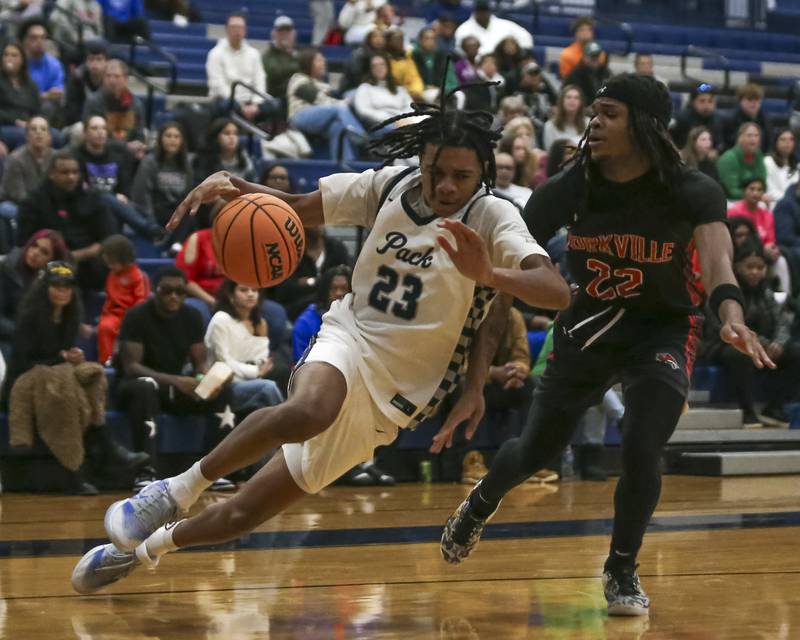 Oswego East's Mason Lockett (23) leans in on a baseline drive to the basket during their basketball game between Yorkville at Oswego East. Friday, Dec 19, 2025 in Oswego.