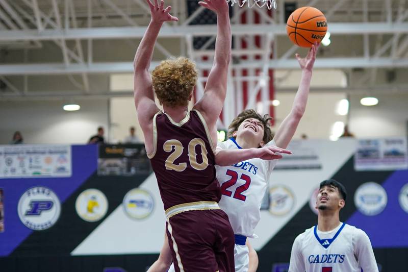 Marmion’s Colin McEniry (22) shoots the ball in the post against Morris’ RJ Kennedy (20) during a basketball game in the opening round of the 61st annual Plano Christmas Classic at Plano High School on Monday, December 23, 2024.