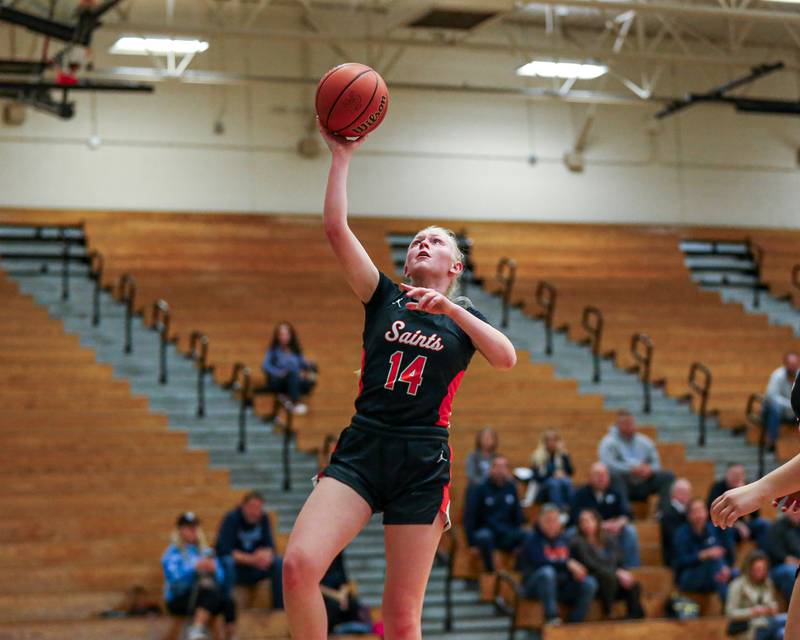 St Charles East's Addie Schilb (14) lays the ball up at the York Thanksgiving Tournament. Nov 13, 2023.