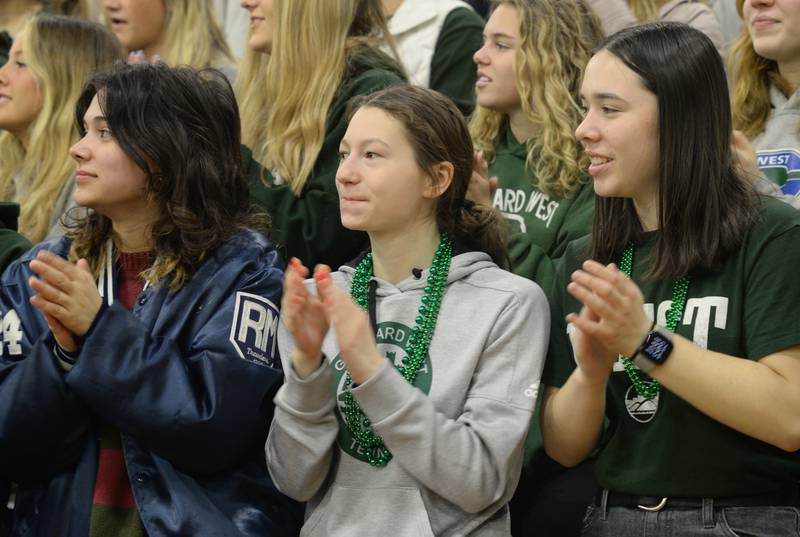 Glenbard West fans including (left-right) Mallory Nikols, Bryan Wheeler, and Maribella Fues cheer for the state basketball team during the pep rally held Sunday March 13, 2022.