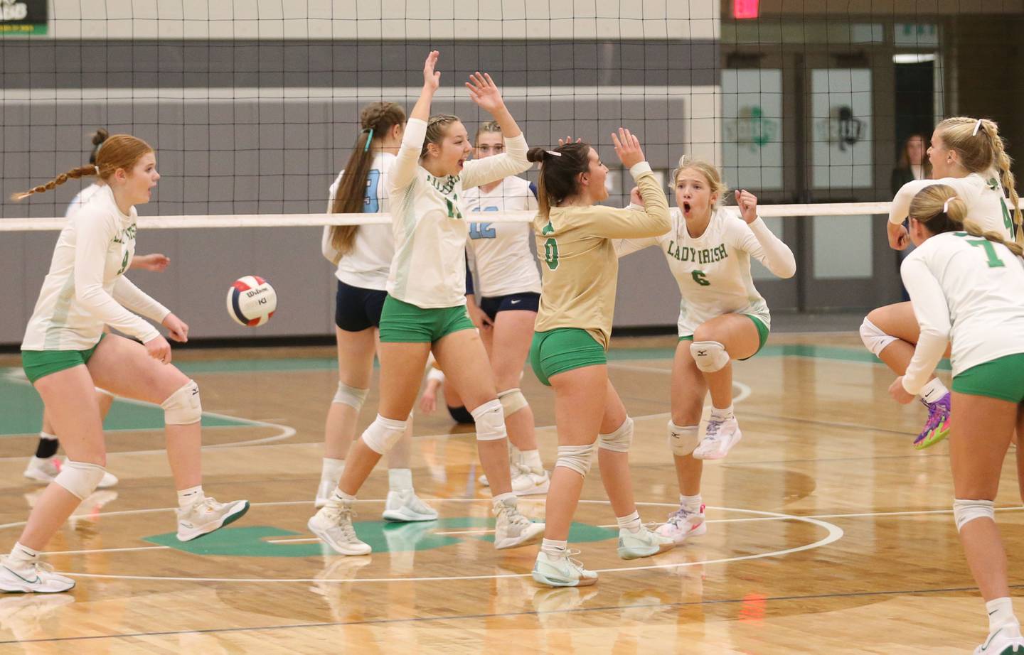 Members of the Seneca volleyball team celebrate after defeating Marquette on Thursday, Sept. 19, 2024 at Seneca High School.