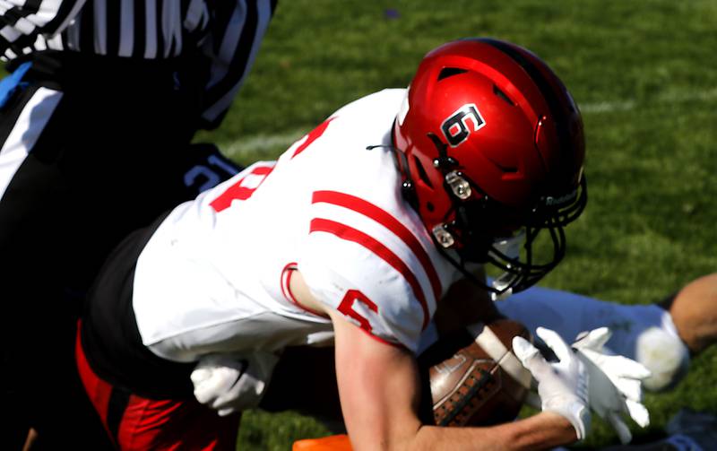 Huntley's Jacob Witt fights through the tackle attempt of Cary-Grove's Patrick Weaver to score a two-point conversion to win a Fox Valley Conference football game on Saturday, Oct. 7, 2023, at Cary-Grove High School.