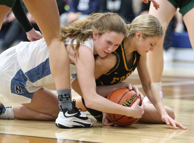 Fremd and Nazareth fight for a loose ball during the girls varsity basketball game on Monday, Jan. 9, 2023 in La Grange Park, IL.