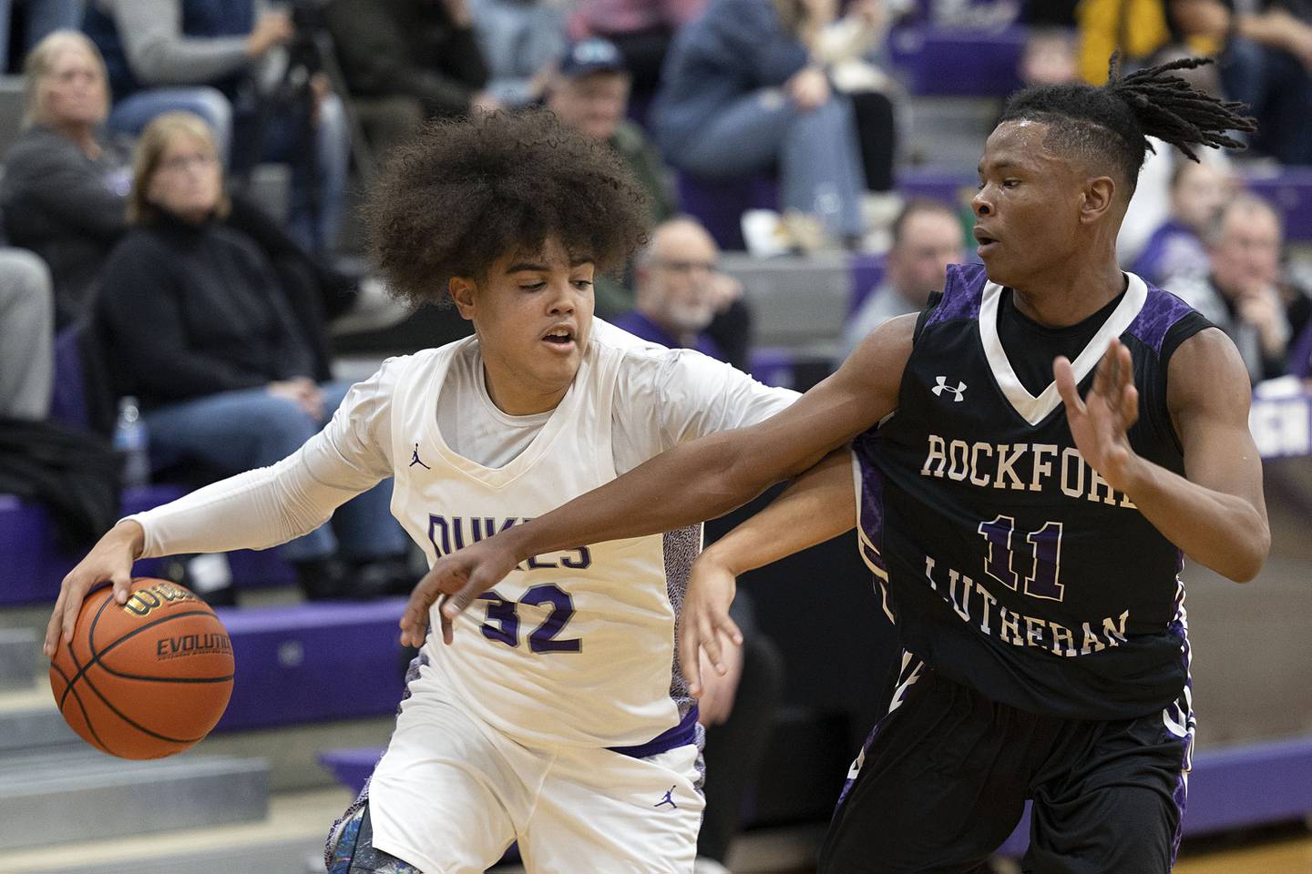 Dixon’s Darius Harrington works against Rockford Lutheran’s Vontez Dent Friday, Jan. 20, 2023.