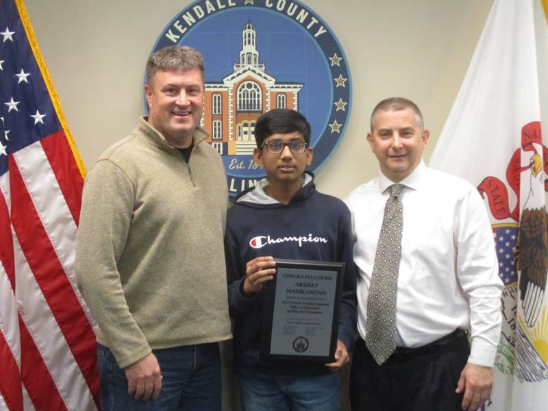 School District 308 eighth-grader Akshay Manikandan was the winner of a regional spelling bee and will go to the national championships later this month. He is seen here on May 2, 2023 with Kendall County Board Chairman Matt Kellogg, left, and Grundy-Kendall Regional School Superintendent Chris Mehochko.