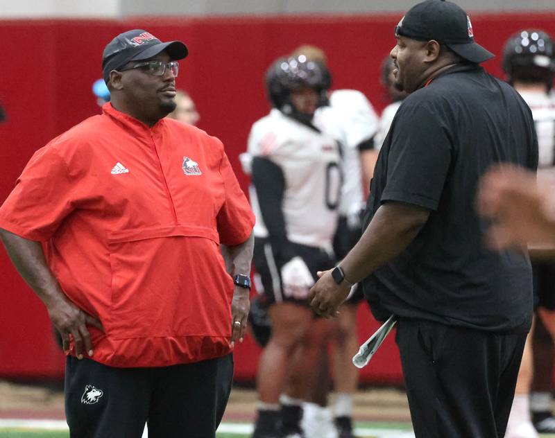 Northern Illinois’ head football coach Thomas Hammock talks to one of his assistants Wednesday, July 30, 2025, at the teams first practice of the season in the Chessick Practice Center at NIU in DeKalb.