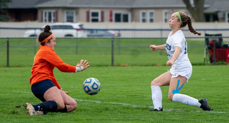 Oswego’s Margaret Leger (0) blocks a shot by Oswego East's Riley Gumm (13) during a soccer match at Oswego High School on Monday, May 2, 2022.