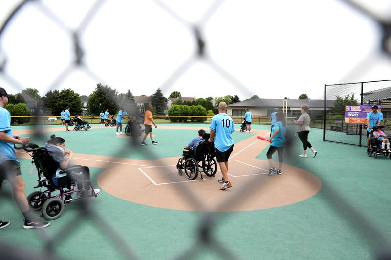 Kane County Cougars players partner with Marklund clients for a softball game at Marklund Hyde Center in Geneva on Tuesday, July 9, 2024.