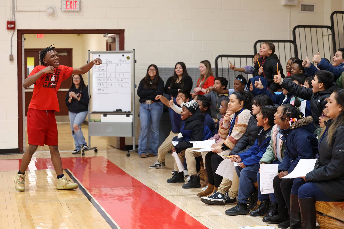 St. Anne High School basketball player Jaquorri Wyatt interacts with grade school students during the district's Math Madness held on March 20 at the high school.