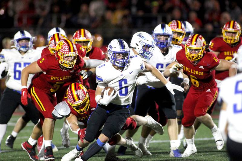 St. Charles North’s Drew Surges (6) runs the ball in the second quarter during a game at Batavia on Friday, Oct. 21, 2022.