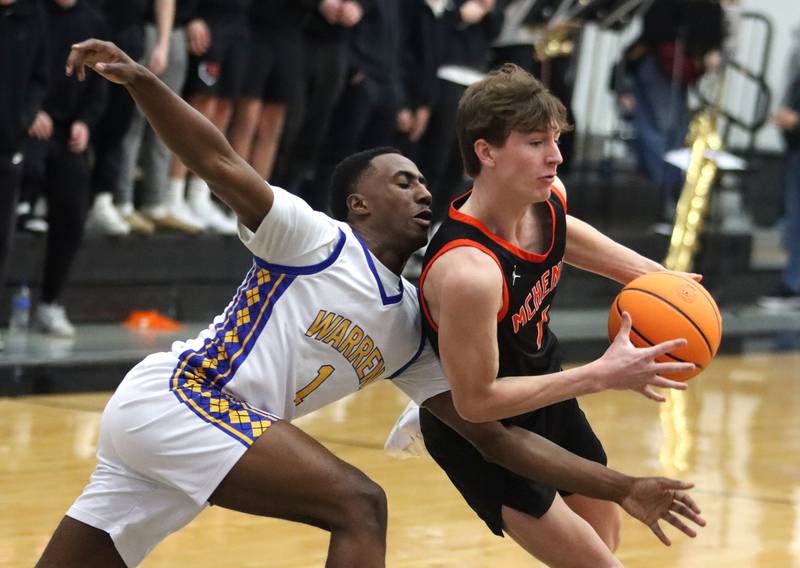 Warren’s Jaxson Davis, back, guards McHenry’s Dylan Hurckes in IHSA Class 4A Regional Title Game boys basketball action on Friday, Feb. 28, 2025 at McHenry High School in McHenry.