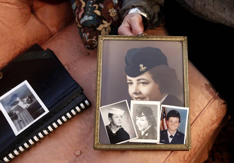 U.S. Navy veteran Donna Vestal shows some photographs of herself and relatives at her home on Thursday, Oct. 17, 2024, in Crystal Lake.
