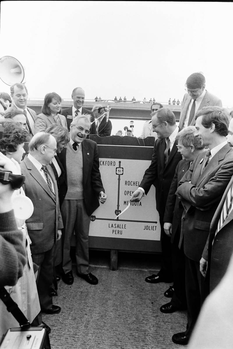 Former Illinois Gov. Jim Thompson, (center) points to Mendota on a map on Friday, Oct. 18, 1985. The headline reads I-39 North: Bold, Beautiful! The ceremony commemorated the opening of Interstate I-39 between Mendota and Rochelle.