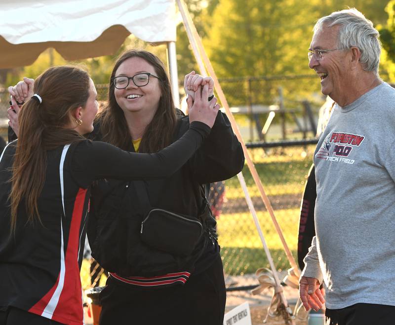 Forreston-Polo's Bree Schneiderman celebrates with coaches Meredith Wolber and Terry Jenkins after winning the 400 meters at the 1A Winnebago Sectional on Wednesday, May 13, 2026.