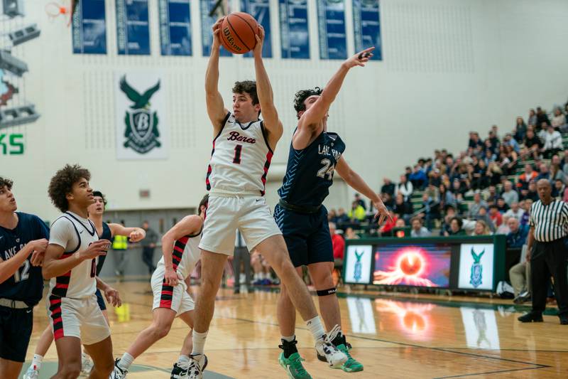 Benet’s Sam Driscoll (1) pulls down a rebound against Lake Park's Dennasio LaGioia (24) during a Bartlett 4A Sectional semifinal boys basketball game at Bartlett High School on Tuesday, Feb 28, 2023.