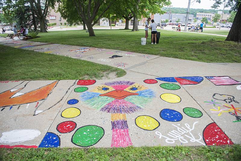 Many colorful works of art can be admired on the sidewalk of the old Lee County Courthouse as part of Petunia Fest’s Brush and Bloom event.