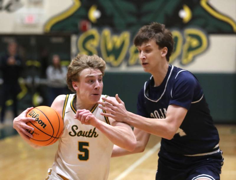 Crystal Lake South's Carson Trivellini drives to the basket agains tCary-Grove's Evan Bauer during a Fox Valley Conference boys basketball game on Friday, Jan. 23, 2026, at Crystal Lake South High School.