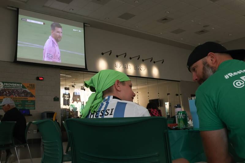 Kevin Rigsby, right, a former classmate of Brad Guzan, talks with his son Miles, a Messi fan, at the Providence Catholic Brad Guzan watch party on Tuesday, July 25 in New Lenox. Guzan is a Providence Catholic alumnus who plays goalie for MLS’ Atlanta United FC.