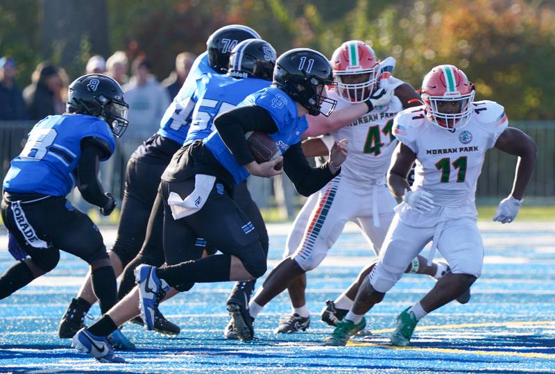 St. Francis' Alessio Milivojevic (11) carries the ball on a keeper against Morgan Park during a class 5A state quarterfinal football game at St. Francis High School in Wheaton on Saturday, Nov 11, 2023.