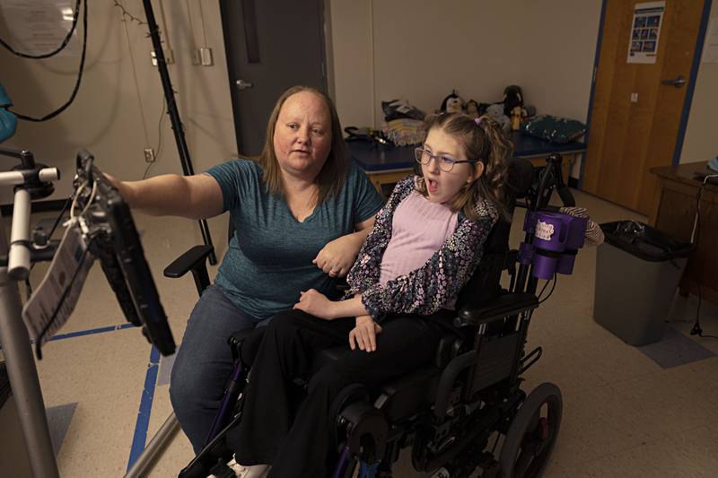 One to one paraprofessional Sherryl Surrena works with student Addy Weidman on a monitor Thursday, April 6, 2023 at Reagan Middle School. Weidman uses eye gaze technology to move items and characters around a screen.