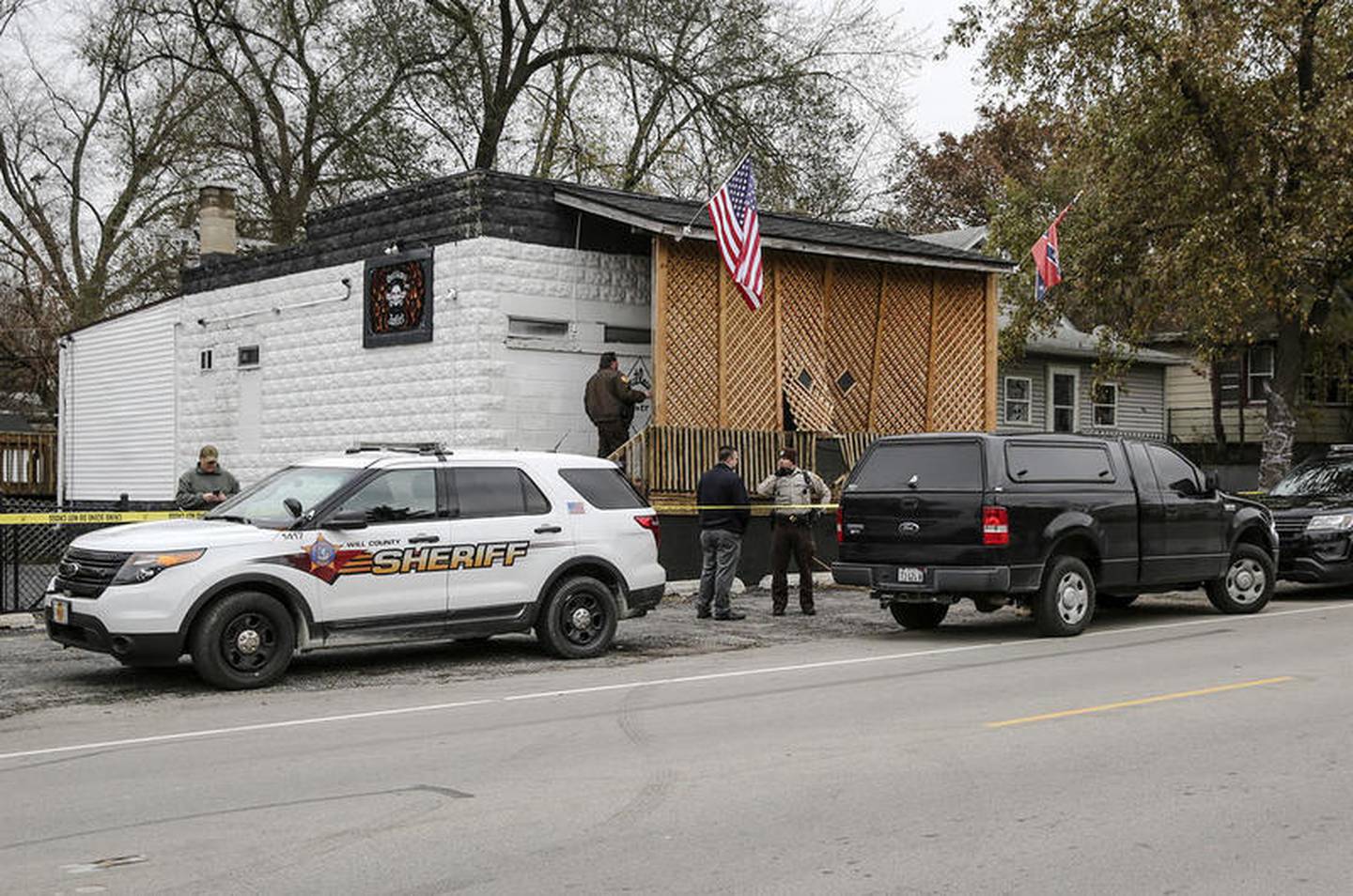 County investigators search the Outlaws' clubhouse Thursday, Nov. 16, 2017, after Kaitlyn Kearns, a 24-year-old bartender from Joliet, was founded dead from a gunshot in a rural area of Kankakee County, according to a sheriff’s office news release Ill.