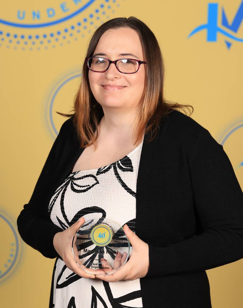 Maurissa Riahi poses with her 40 Under Forty award during the Illinois Valley Chamber of Commerce Champions of Change Awards Night on Thursday, April 10, 2025 at the Westclox Event Center in Peru.