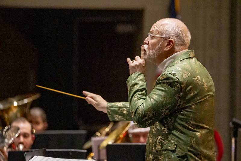TubaChristmas Conductor, Kevin Johnson sends signals to quite part of the tuba orchestra on December 15, 2024 at Hall High School.