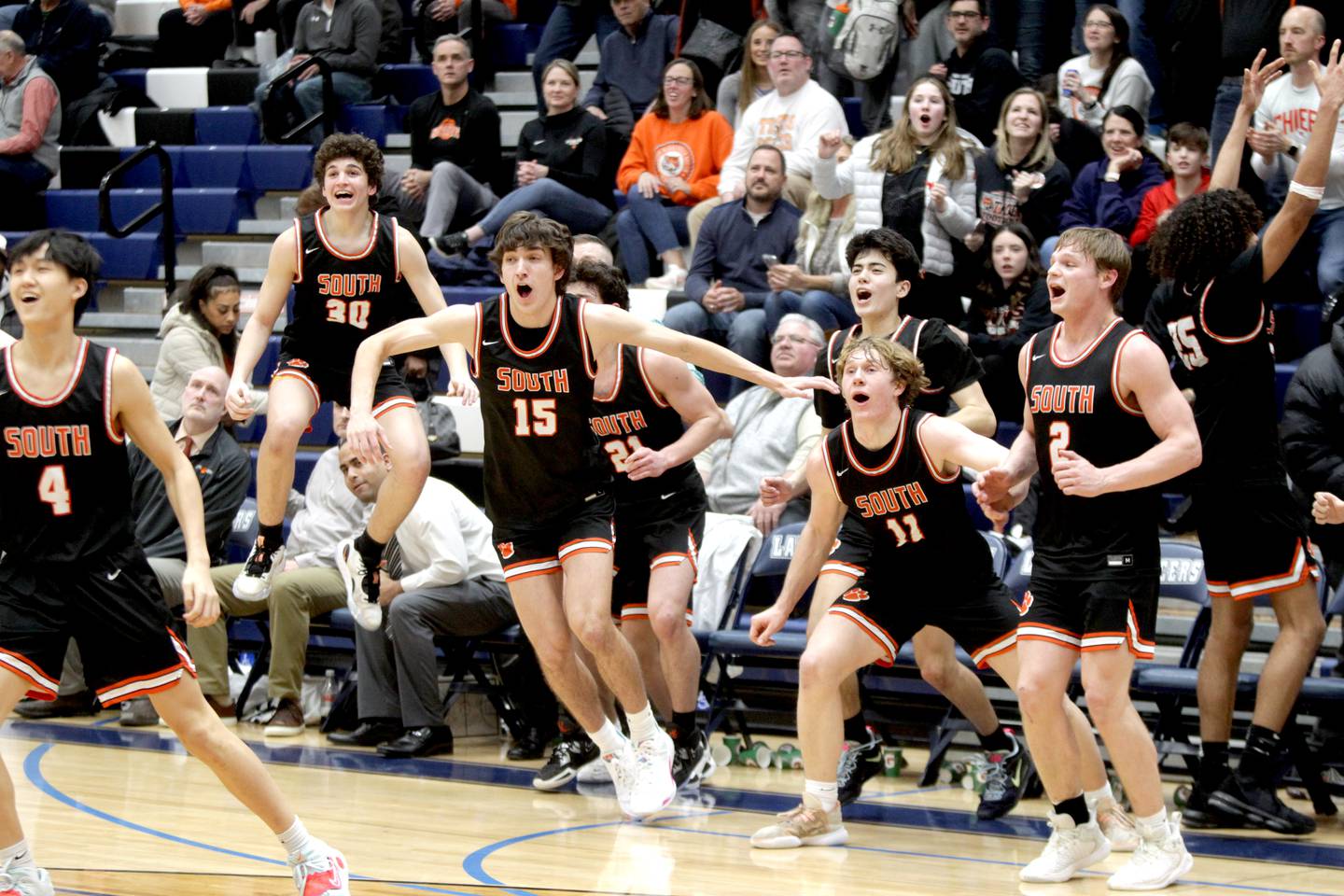 The Wheaton Warrenville South bench erupts as they clinch their win over Lake Park in Roselle on Friday, Feb. 10, 2023.