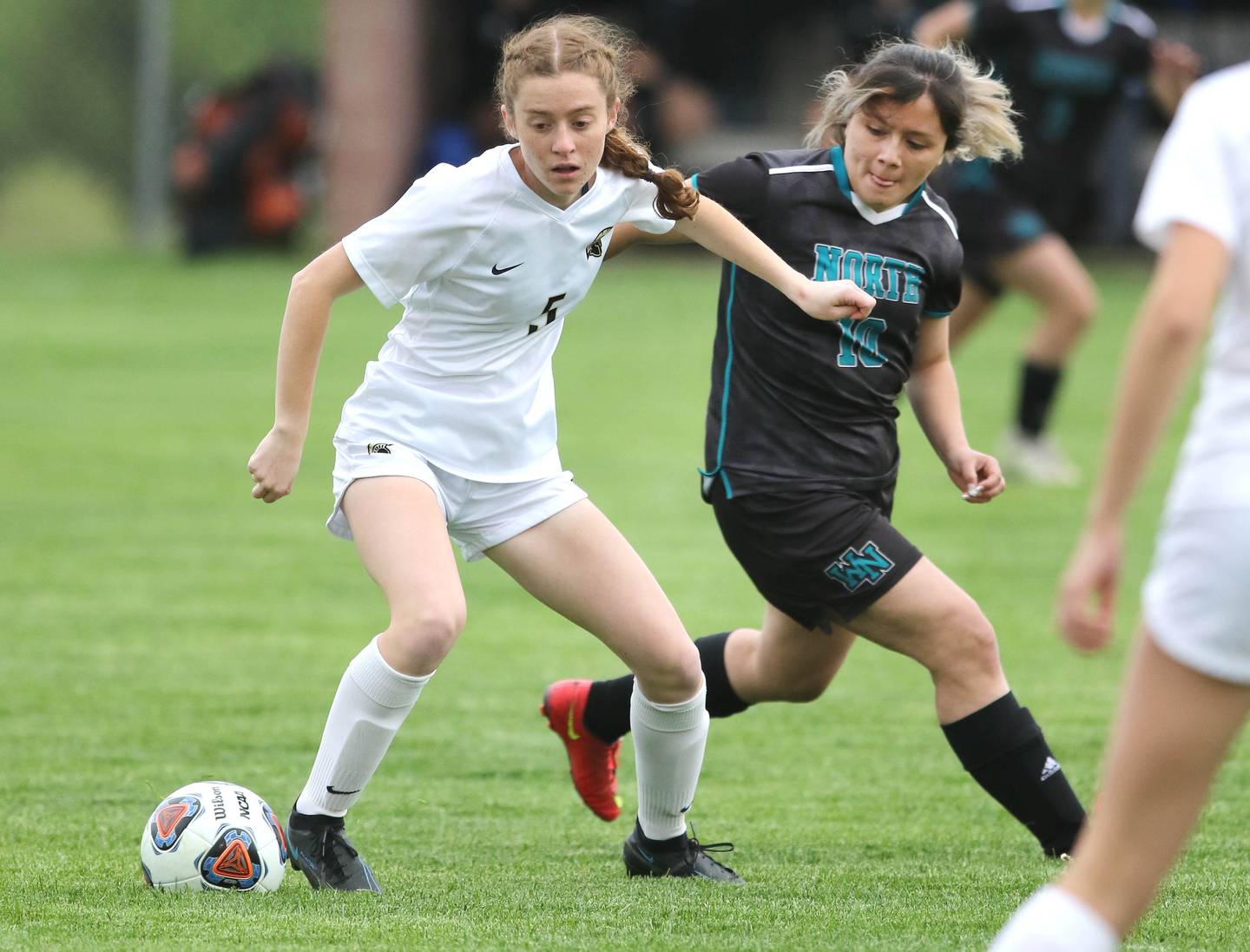 Sycamore's Grace Parks and Woodstock North's Karen Zamudio go after the ball during their IHSA Class 2A regional game Tuesday, May 17, 2022, at Burlington Central High School.