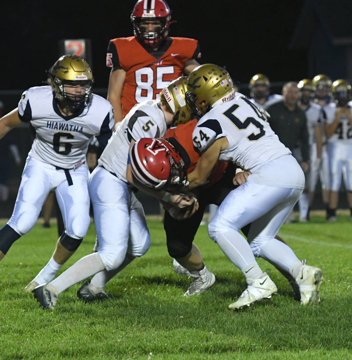 Hiawatha's Thomas Butler (5) and Ryan Barber (54) wrap up an Amboy running back during Friday. Sept 30 action in Amboy.
