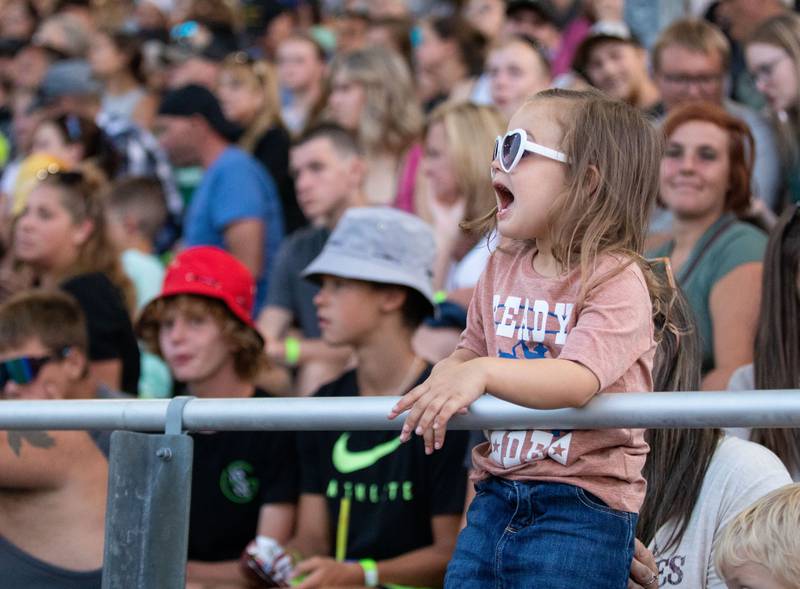 Ainsley Singer, 2, cheers on the bull riders during the 75th Anniversary of the McHenry County Fair in Woodstock on Friday, August 4, 2023.